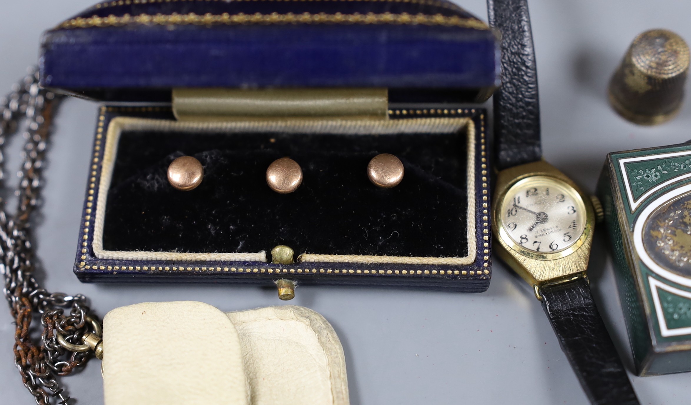An early 20th century lady's 9ct gold wrist watch and sundry minor jewellery and accessories, including a German 950 white metal and enamel pill box.